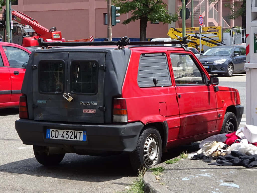Vintage Red Fiat Panda Wallpaper: Classic Car in Urban Setting