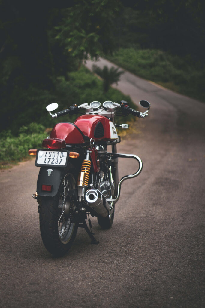 Vintage Red Motorcycle Wallpaper: Serene Road & Lush Greenery Background