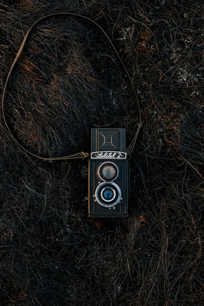Vintage Retro Camera Wallpaper on Textured Grass Surface