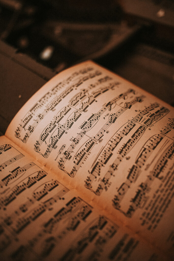 Vintage Sheet Music Wallpaper: Timeless Creativity in Warm Atmosphere