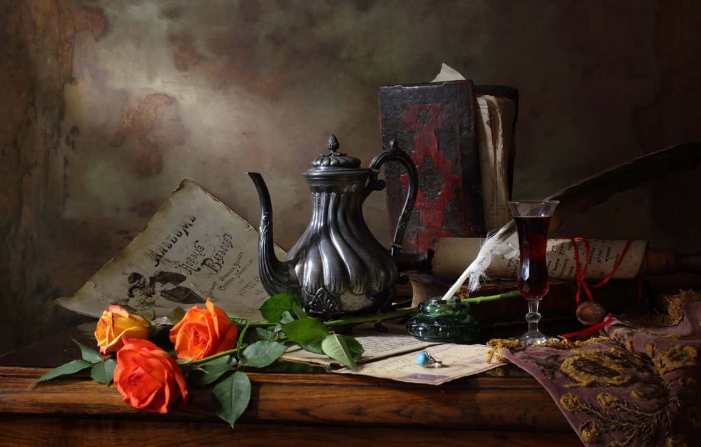 Vintage still life wallpaper with silver teapot orange roses antique books quill and fine wine