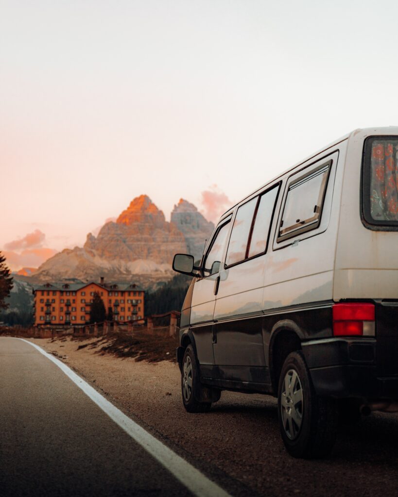 Vintage Van Sunset: Scenic Roadside Adventure Wallpaper