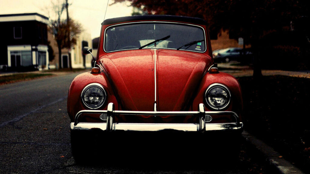 Vintage Wallpaper: Classic Red Volkswagen Beetle on Quiet Street