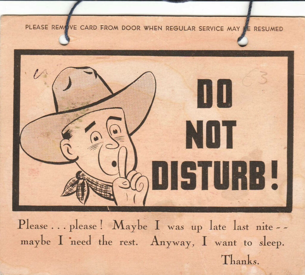 Vintage Western wallpaper cartoon cowboy shh gesture Do Not Disturb sign retro sepia tones