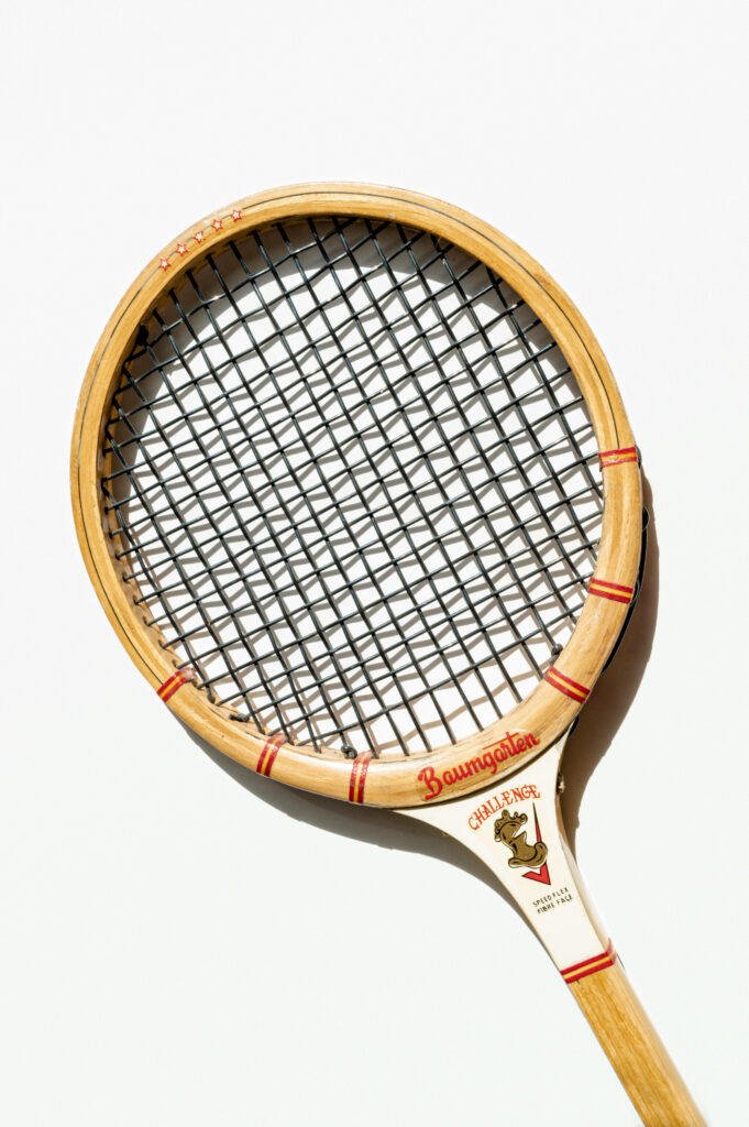 Vintage Wooden Squash Racket: Classic Design on White Wallpaper