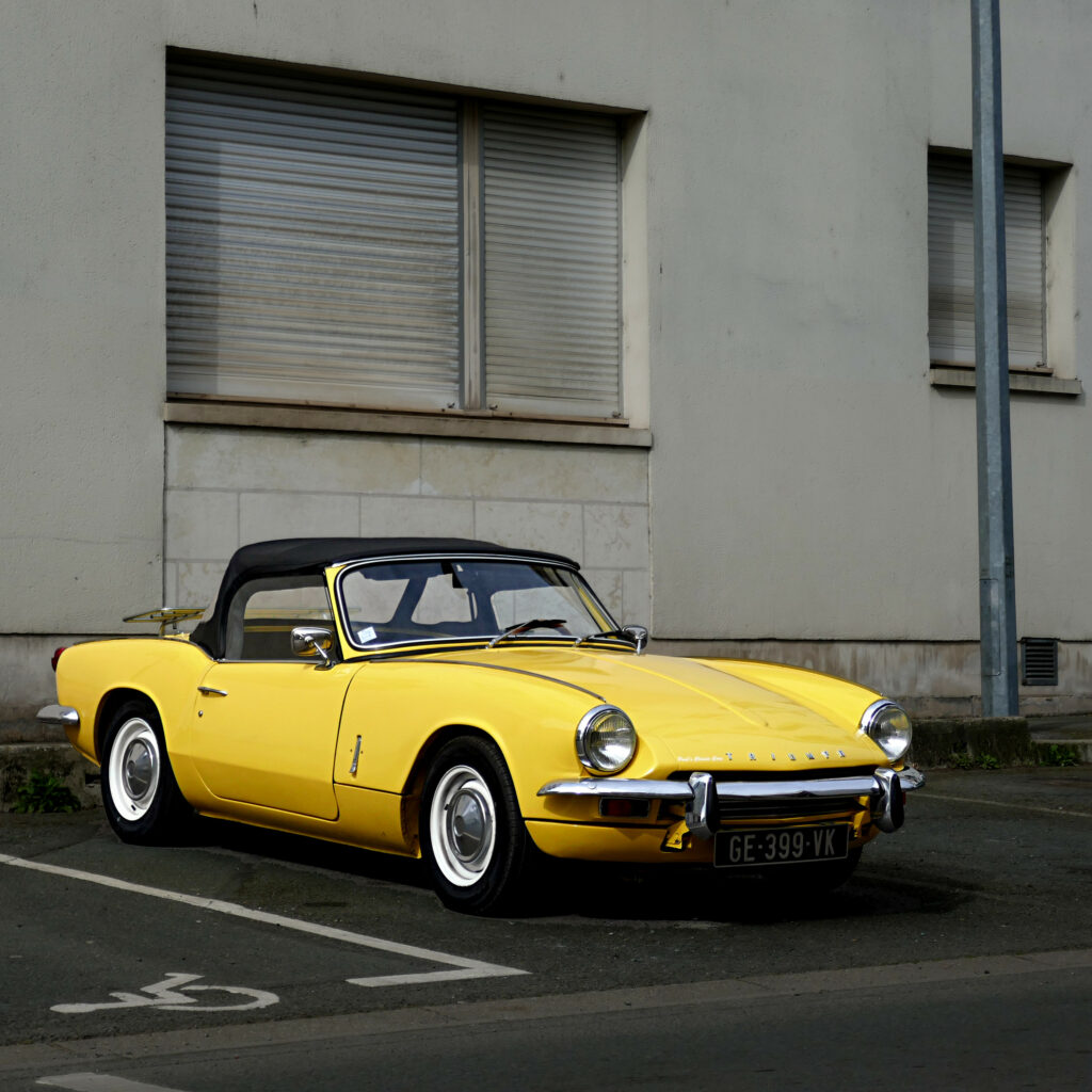 Vintage Yellow Convertible Wallpaper: Urban Retro Car Aesthetic