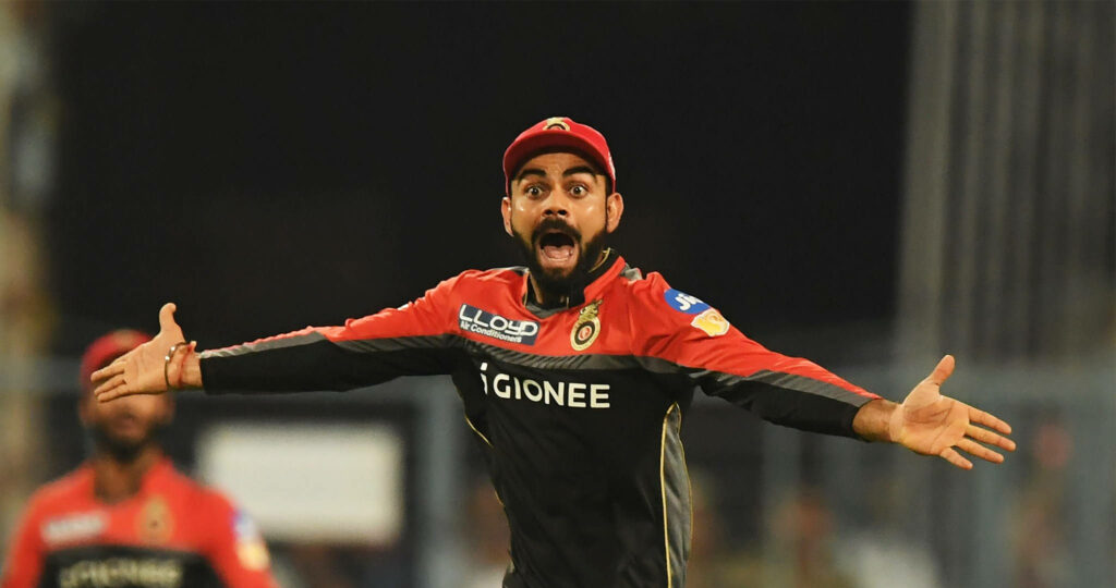 Virat Kohli RCB jersey celebrates passionately with arms outstretched iconic cricket moment wallpaper