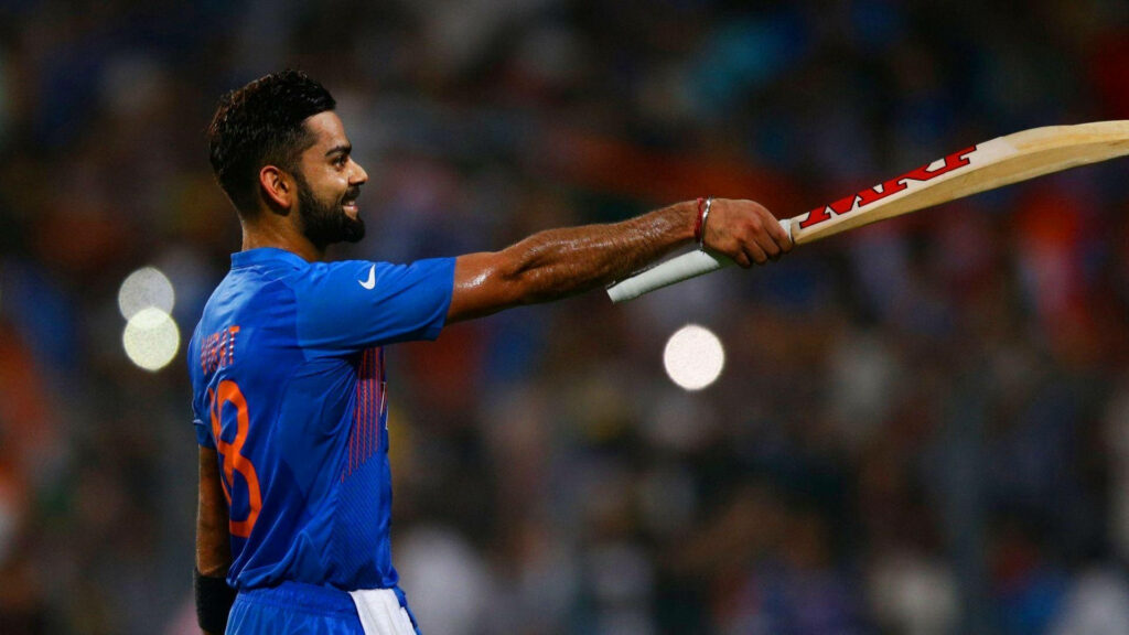 Cheering On: Virat Kohli's Winning Grin Amidst The Crowd Wallpaper
