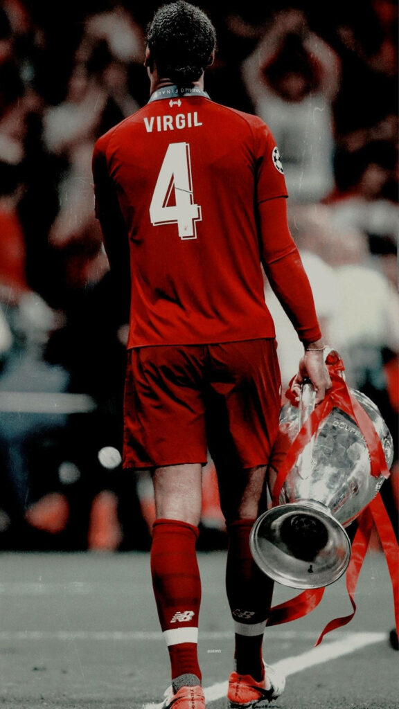 Virgil Van Dijk in red kit holding Championship Cup victorious football moment wallpaper background