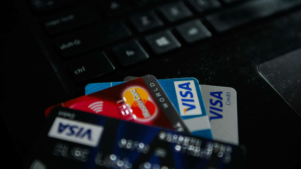Close-up of Visa and Mastercard credit cards on laptop keyboard highlighting online payments security Wallpaper