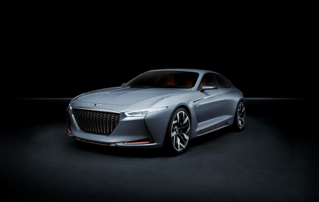 Cutting-Edge Genesis Concept Car: Striking Steel Gray Design in Dimly Lit Exhibition Space Wallpaper