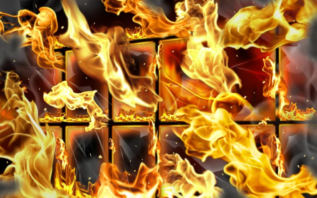 Intense Fire Wallpaper: Roaring Flames & Wire Mesh Structure Background