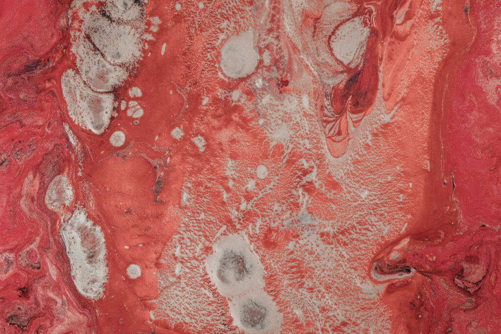 Vivid Red and White Abstract Wallpaper: Dynamic Paint-Stained Design