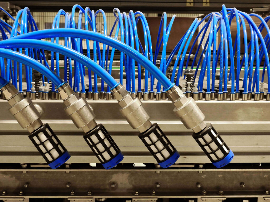 Close-up of vivid blue Ethernet cables in parallel rows connected to metal network connectors Wallpaper