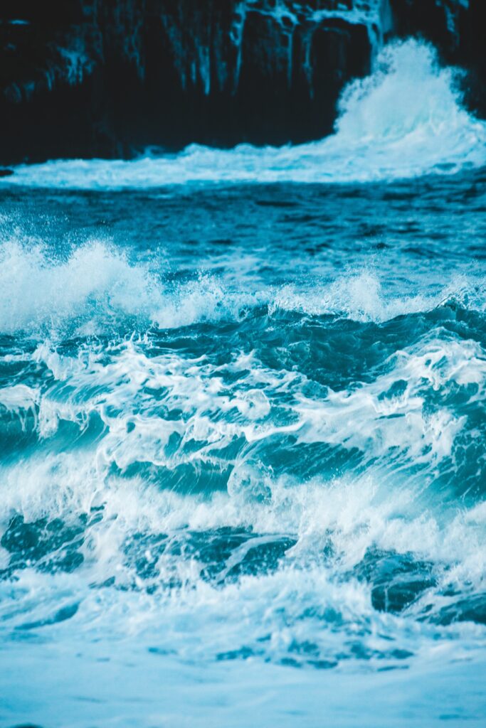 Vivid blue river with rolling waves and sprays in high resolution natural light wallpaper background