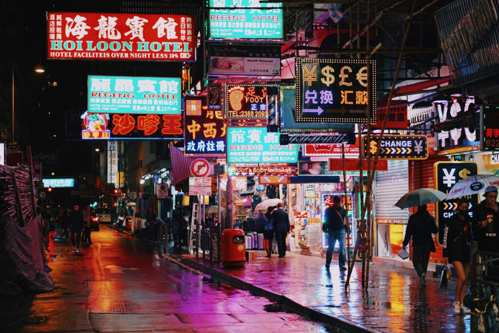 Vivid Hong Kong Night Scene: Neon Lights & Wet Streets Wallpaper