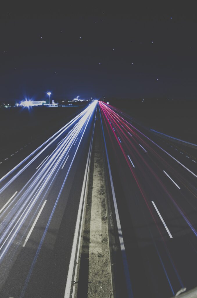 Mesmerizing Nighttime Highway Wallpaper with Vivid Light Trails