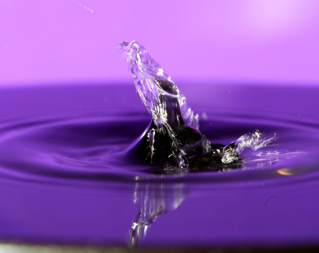 Stunning Water Splash Wallpaper on Vibrant Purple Background