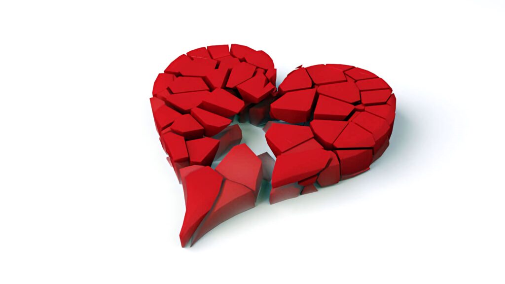 Vivid red broken heart made of scattered fragments on white background symbolizing heartbreak Wallpaper