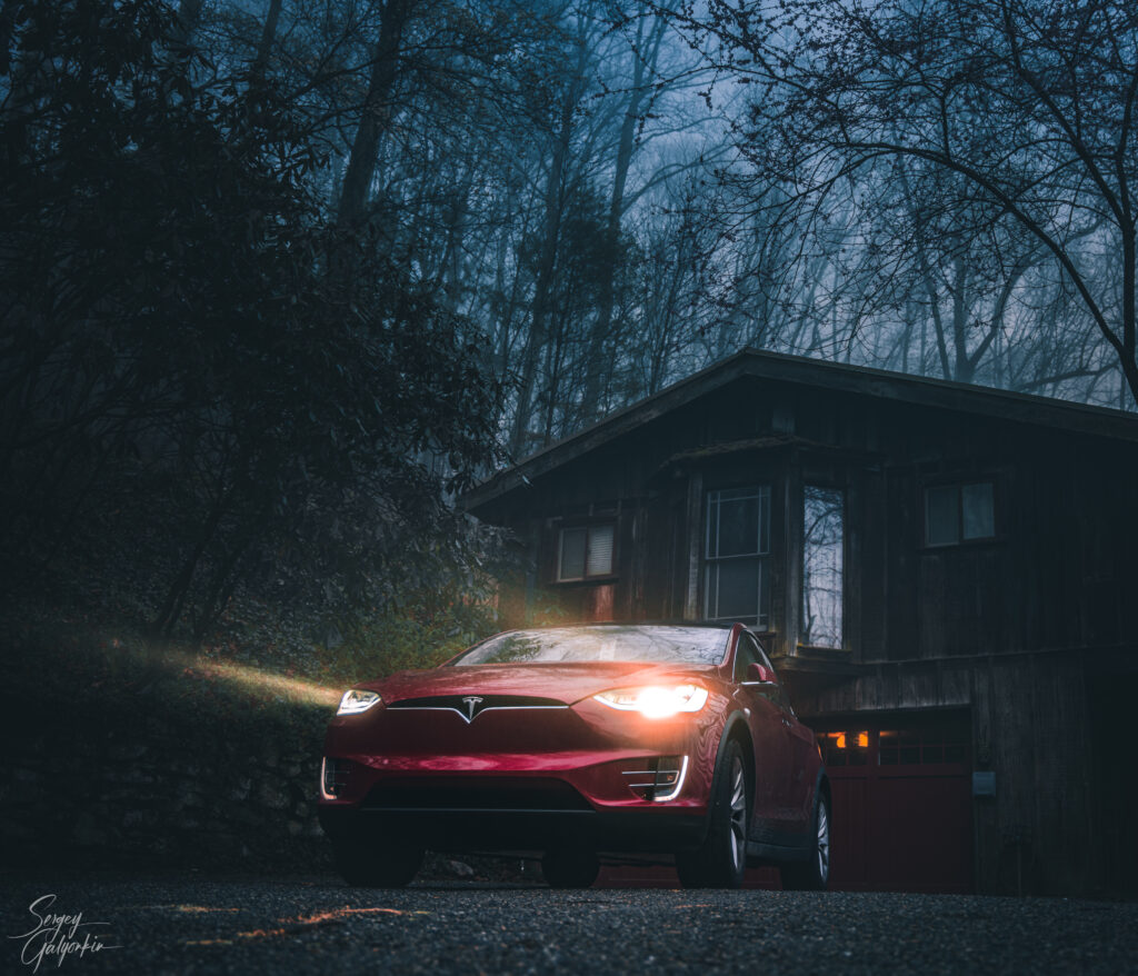 Vivid Red Tesla Model S: Striking Wallpaper with Mystical Background