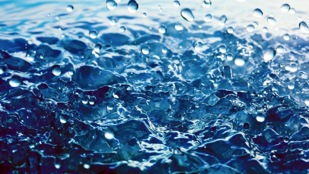 Vivid Water Droplets Wallpaper: Rain Splashing & Rippling Background