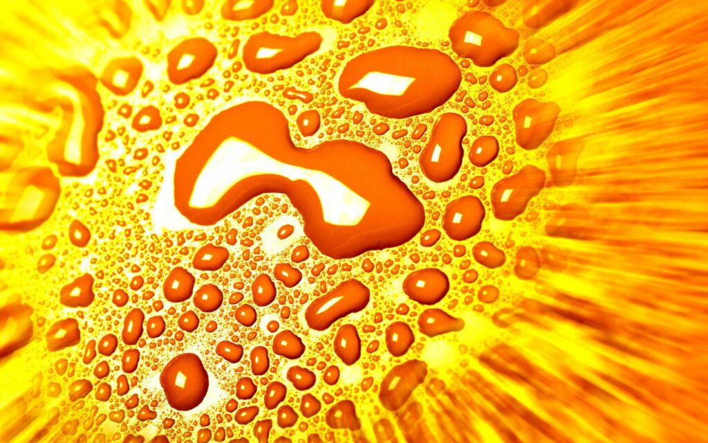 Vivid Yellow Liquid Drops Wallpaper: Dynamic Radiant Background Art