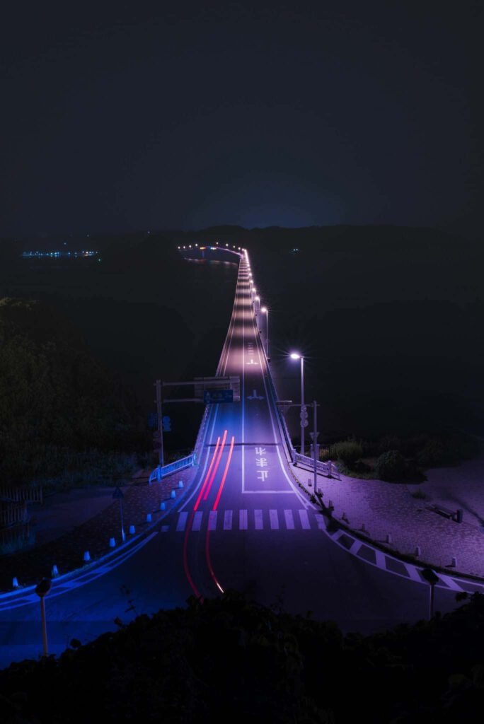 Luminous Pathways: An Aesthetic Vaporwave Snapshot of an Illuminated Empty Highway Wallpaper