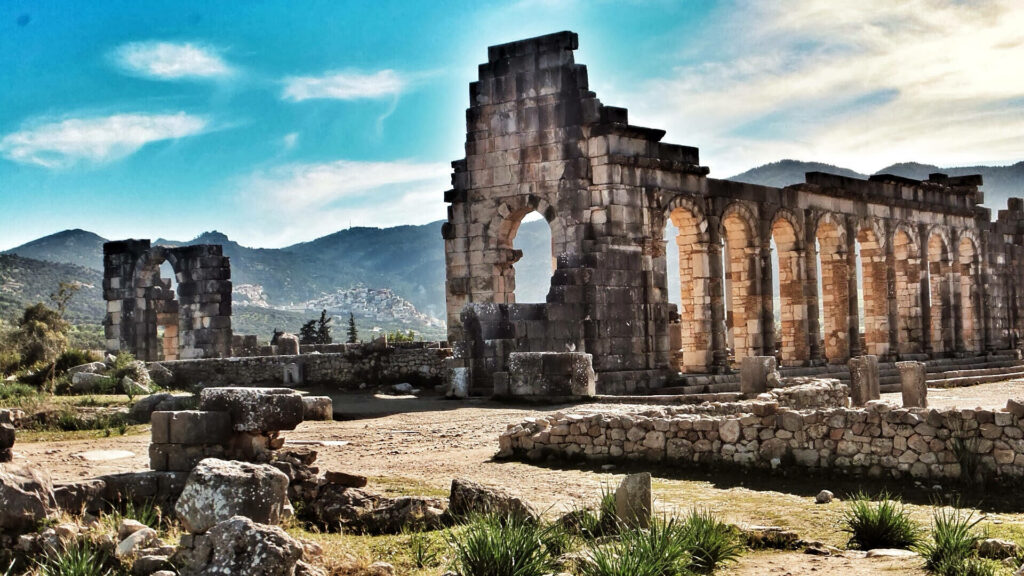 Stunning Volubilis Ruins Wallpaper: Arches & Mountains in Morocco