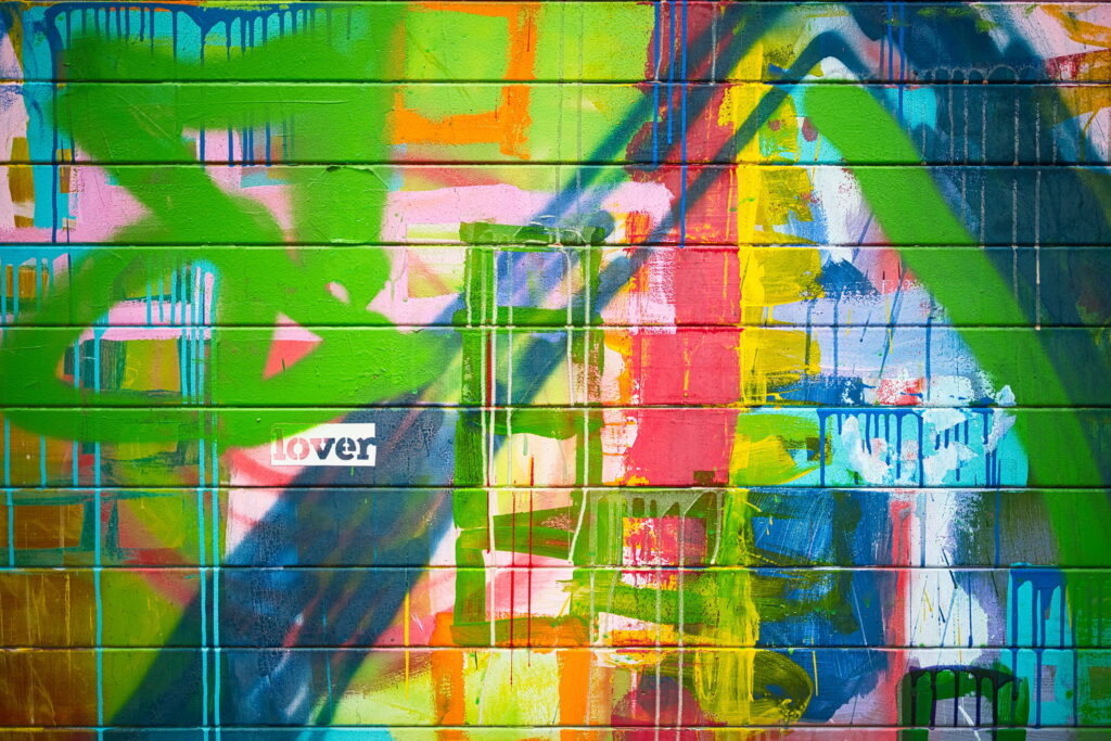 Urban Elegance: Captivating Graffiti Wall with Inscriptions - A HD Wallpaper Background