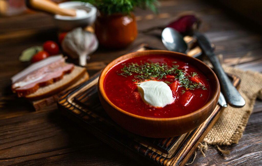 Rustic Wallpaper: Hearty Borscht in Wooden Bowl with Fresh Herbs