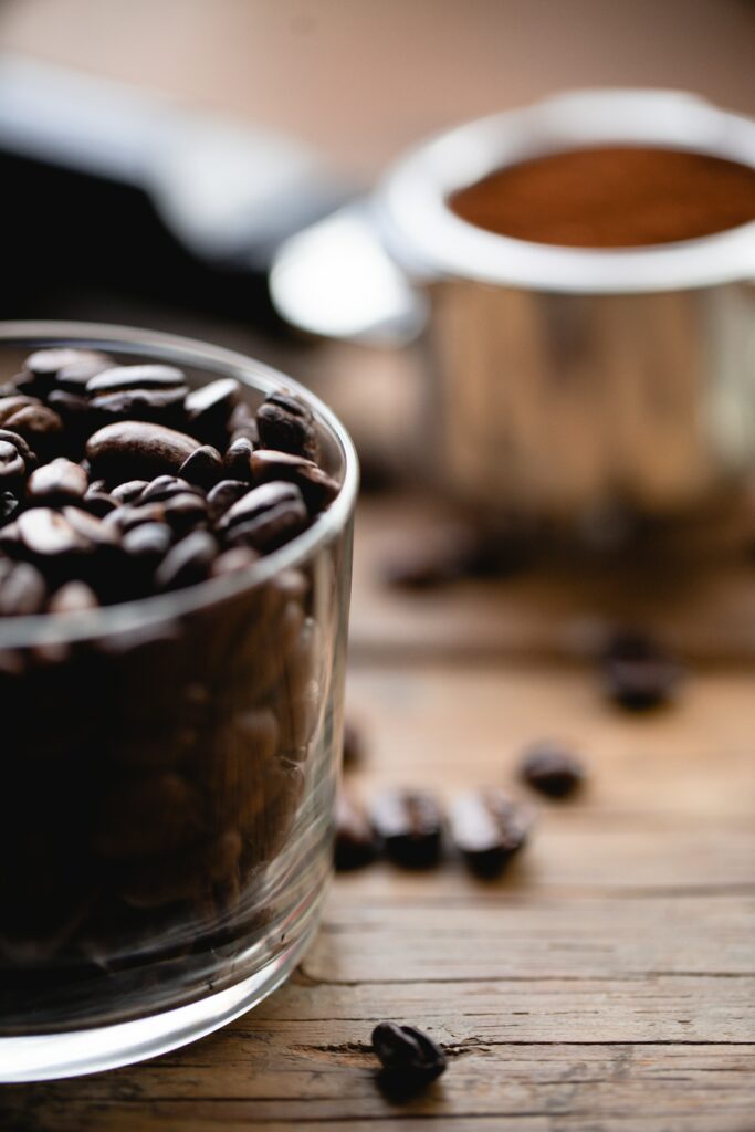Warm Coffee Beans Close-Up Wallpaper on Wooden Surface