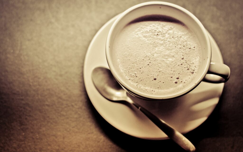 Steaming Coffee Cup on Saucer: Warm Ambiance Wallpaper Background