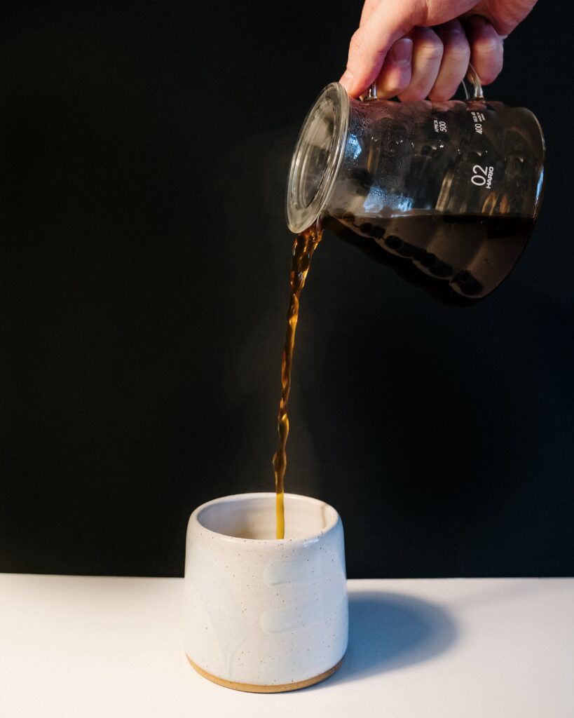 Cozy Coffee Stream: Hot Brew in White Ceramic Cup Wallpaper