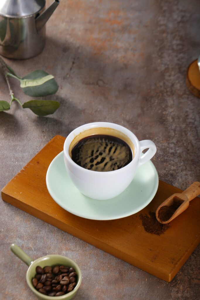 Warm Coffee Wallpaper: Fresh Brew on Green Saucer & Rustic Decor