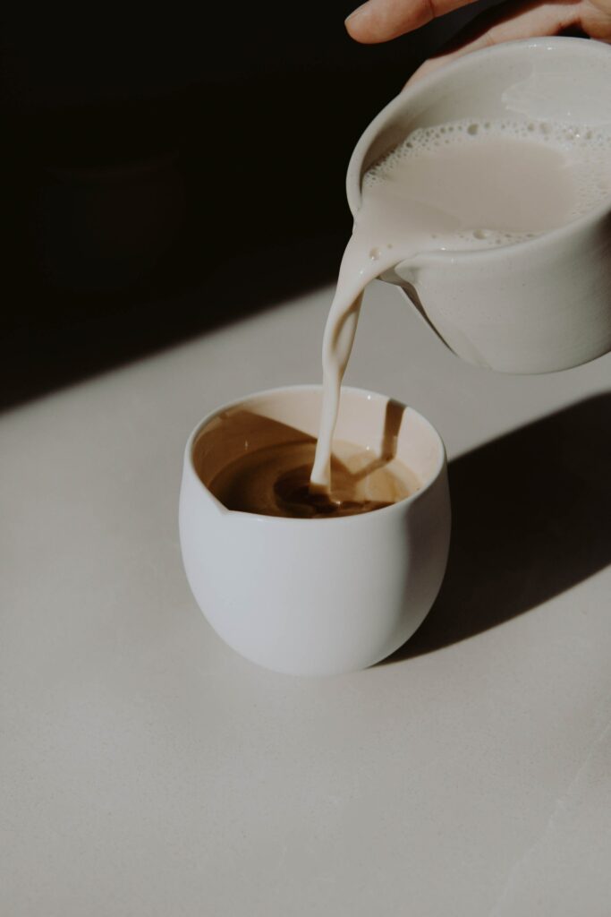 Warm Wallpaper: Milk Poured into Coffee on Minimalistic Background