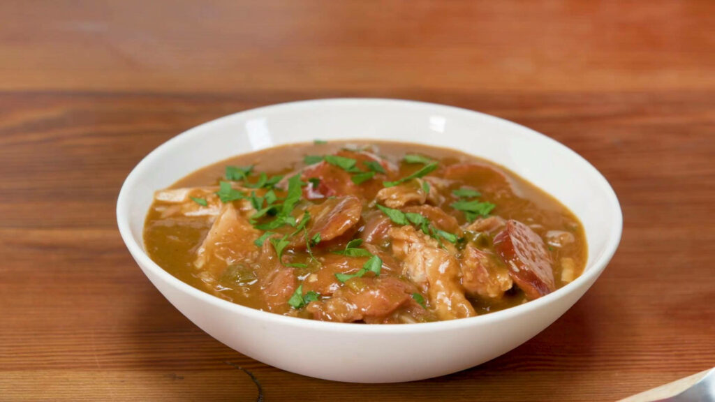 Hearty Gumbo in White Bowl with Fresh Herbs - Rustic Wallpaper
