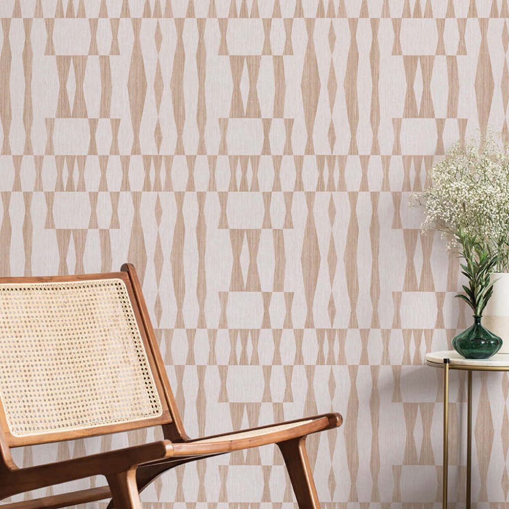Warm minimalist room with wooden rattan chair, gold side table, floral decor, geometric wallpaper