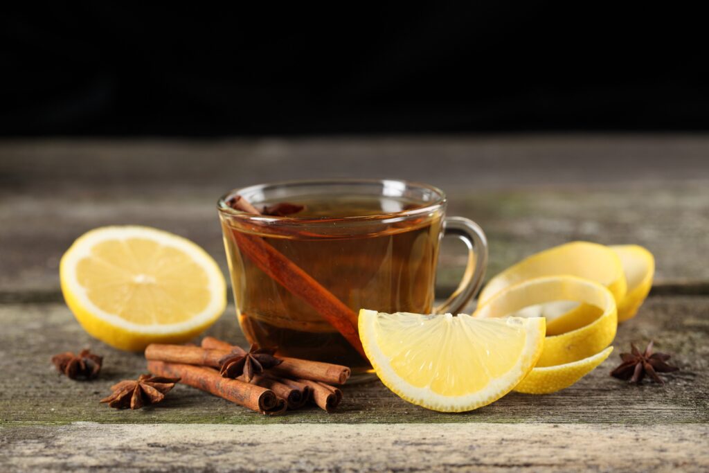 Cinnamon Tea Wallpaper: Cozy Cup with Lemon on Rustic Wood