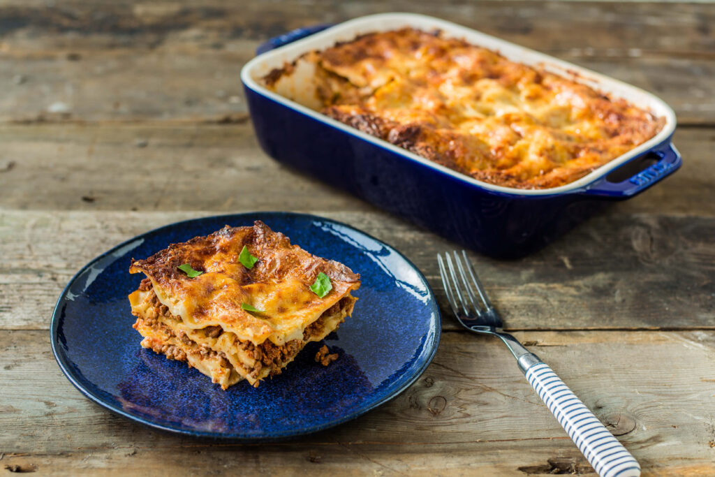 Rustic Wallpaper: Fresh Lasagna Alla Bolognese on Wooden Table