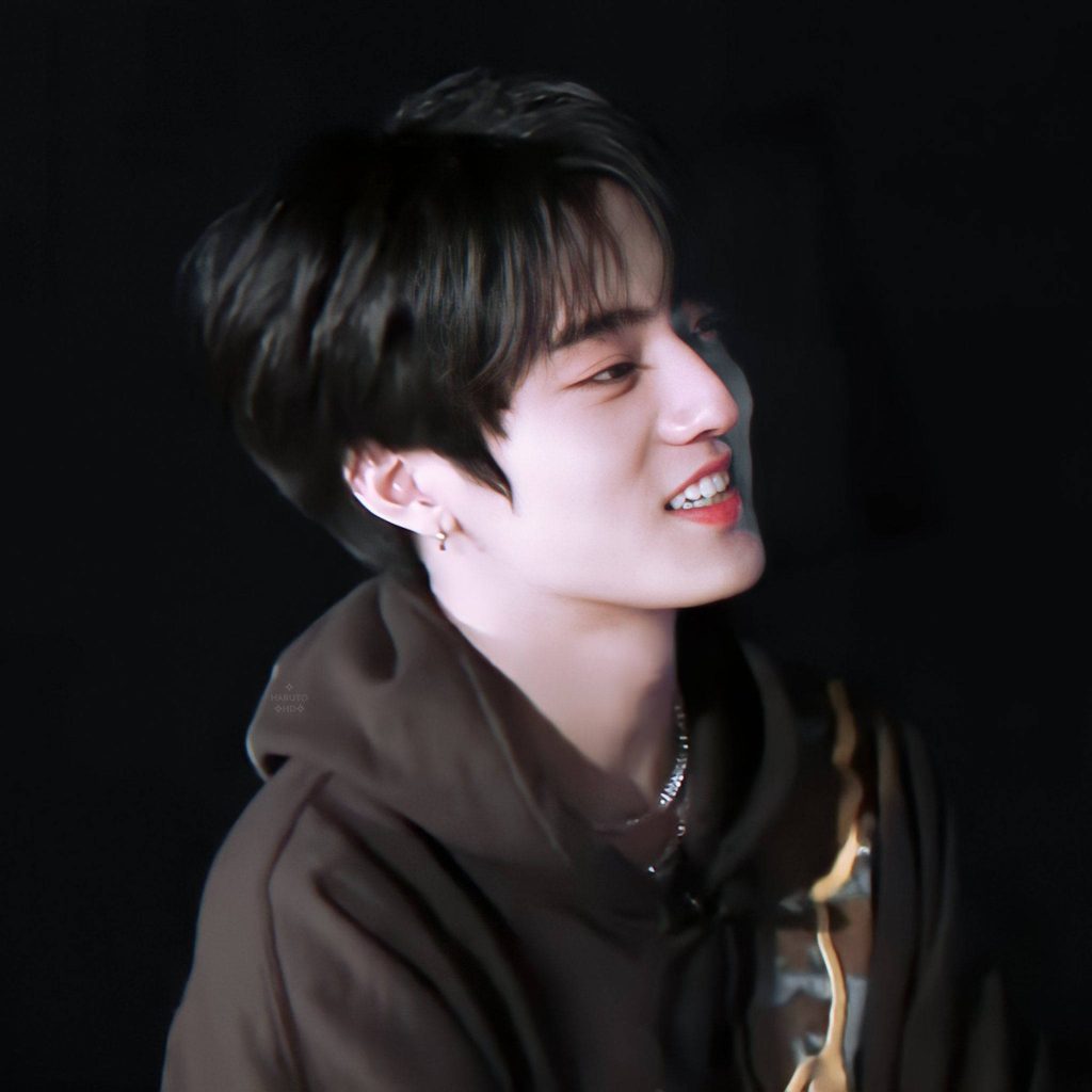K-Pop idol Watanabe Haruto smiling in dark hoodie HD wallpaper with moody black background