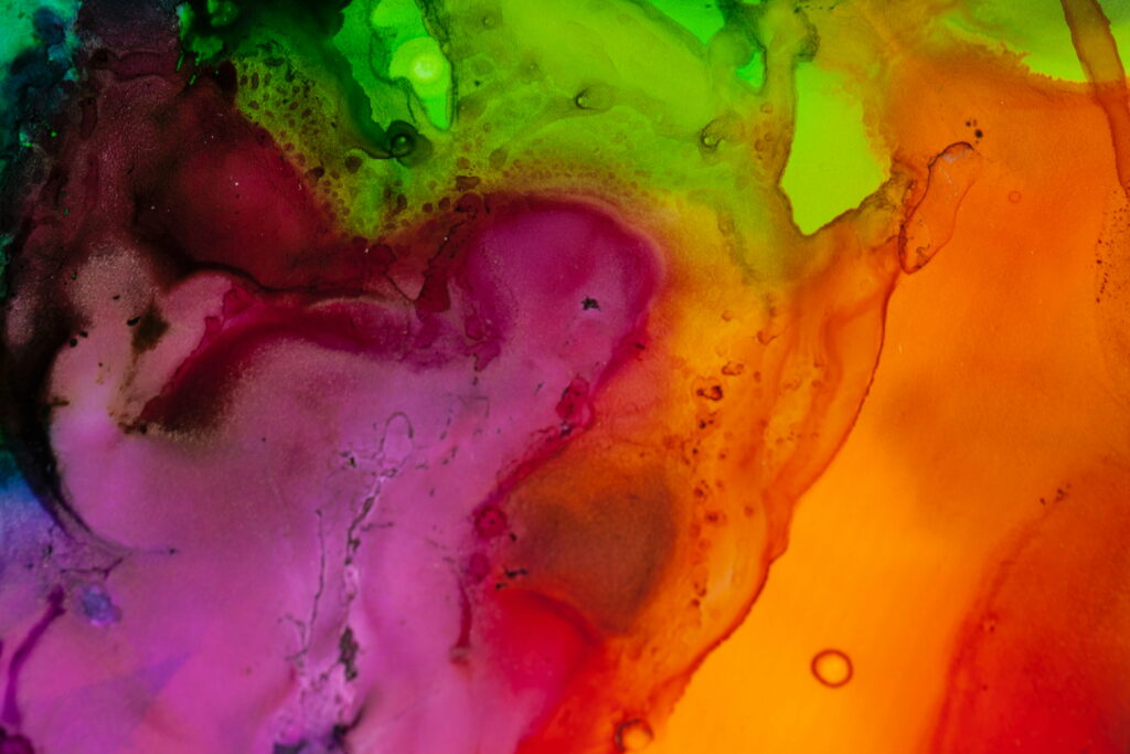 Abstract wallpaper with flowing magenta neon orange and lime green watercolor stains background