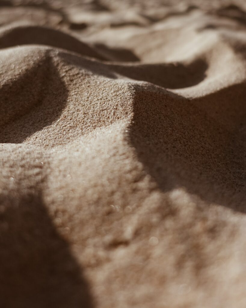 Wavy Sand Texture Close-Up: Fine Details & Light Play Wallpaper
