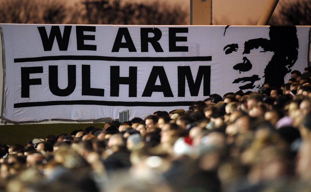 Fulham FC stadium banner featuring Johnny Haynes portrait at Craven Cottage black and white Wallpaper