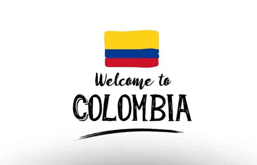 Colombian flag waving above bold Welcome to Colombia text vibrant country introduction wallpaper