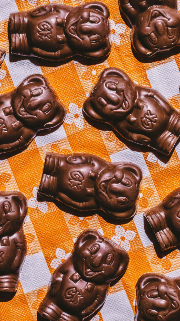 Charming Chocolate Koala Snacks on Orange Checkered Background Wallpaper