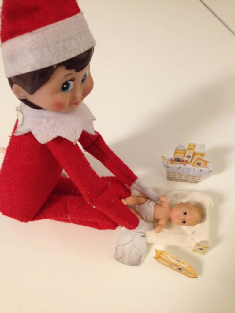 Playful Elf on the Shelf Changing Doll's Diaper - Whimsical Wallpaper