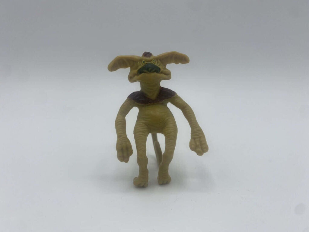 Whimsical Green Creature Wallpaper with Large Ears on Light Background