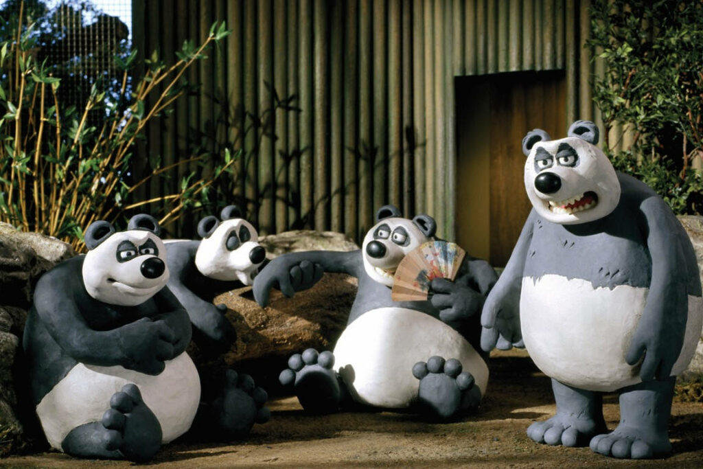 Charming Panda Wallpaper: Playful Animated Scene in Whimsical Setting