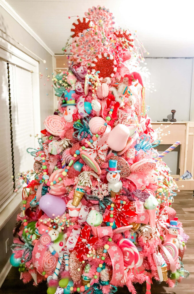 Whimsical Pink Christmas Tree Wallpaper with Cheerful Decorations