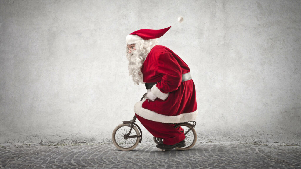 Whimsical Santa on Tiny Bicycle: Fun Festive Wallpaper Design